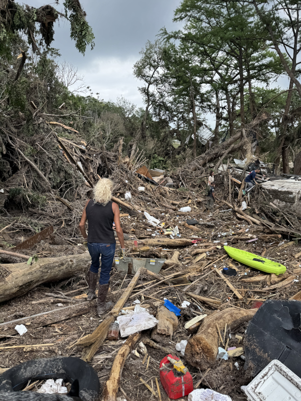 Camper examines the devastation after her RV was swept away.