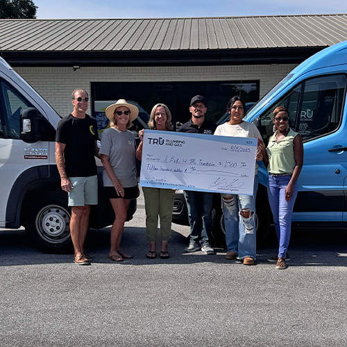 Cody and Erika Kearns from Tru Plumbing and Gas pose with Diane Freeman, Executive Director of A Bed 4 Me Foundation and her team
